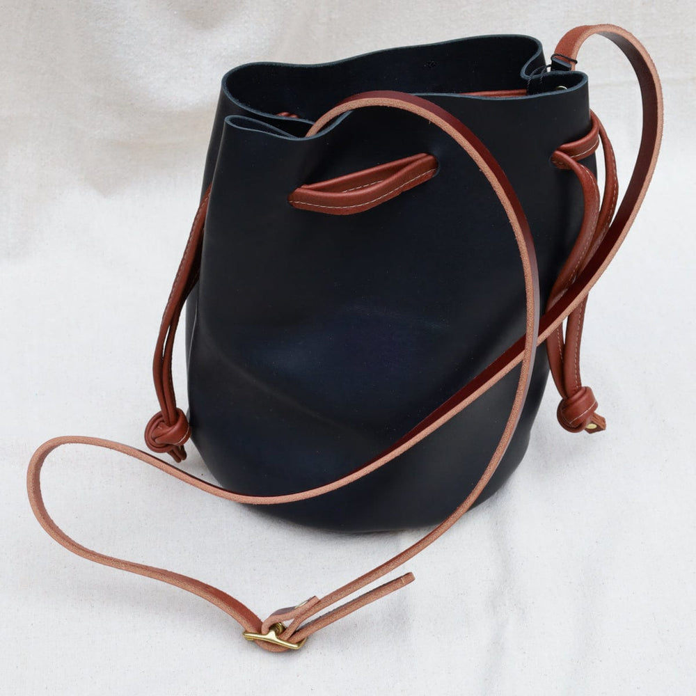 
                      
                        BAG The Ana Bucket in Black with Cognac
                      
                    