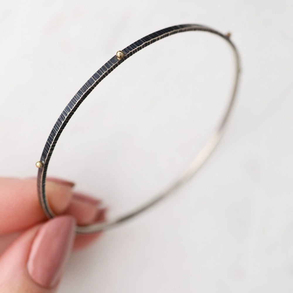 
                  
                    BRC-18K Dot Bangle in Oxidized Silver & 18k Gold
                  
                