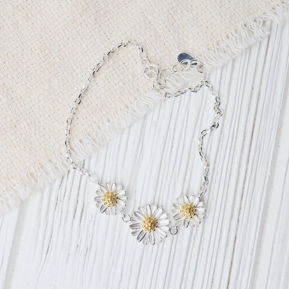 
                      
                        BRC 3 Silver Daisies with Gold Plated Centers Bracelet
                      
                    