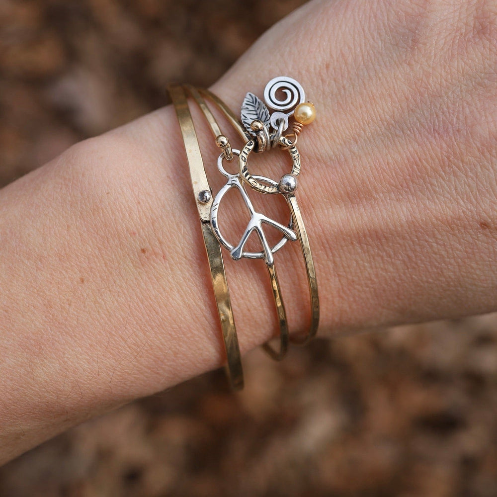 
                  
                    BRC-BRASS Brass Bracelet with Silver Peace Symbol
                  
                