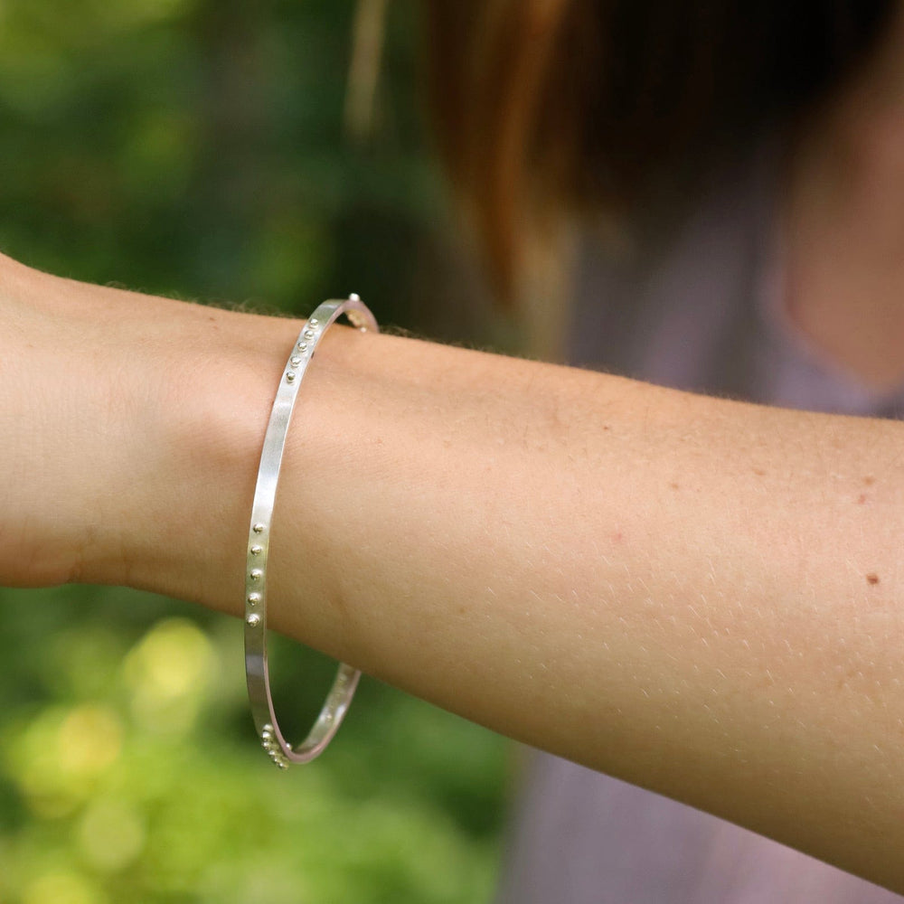 
                  
                    BRC Five Kinetic Dot Bangle in Polished Silver
                  
                