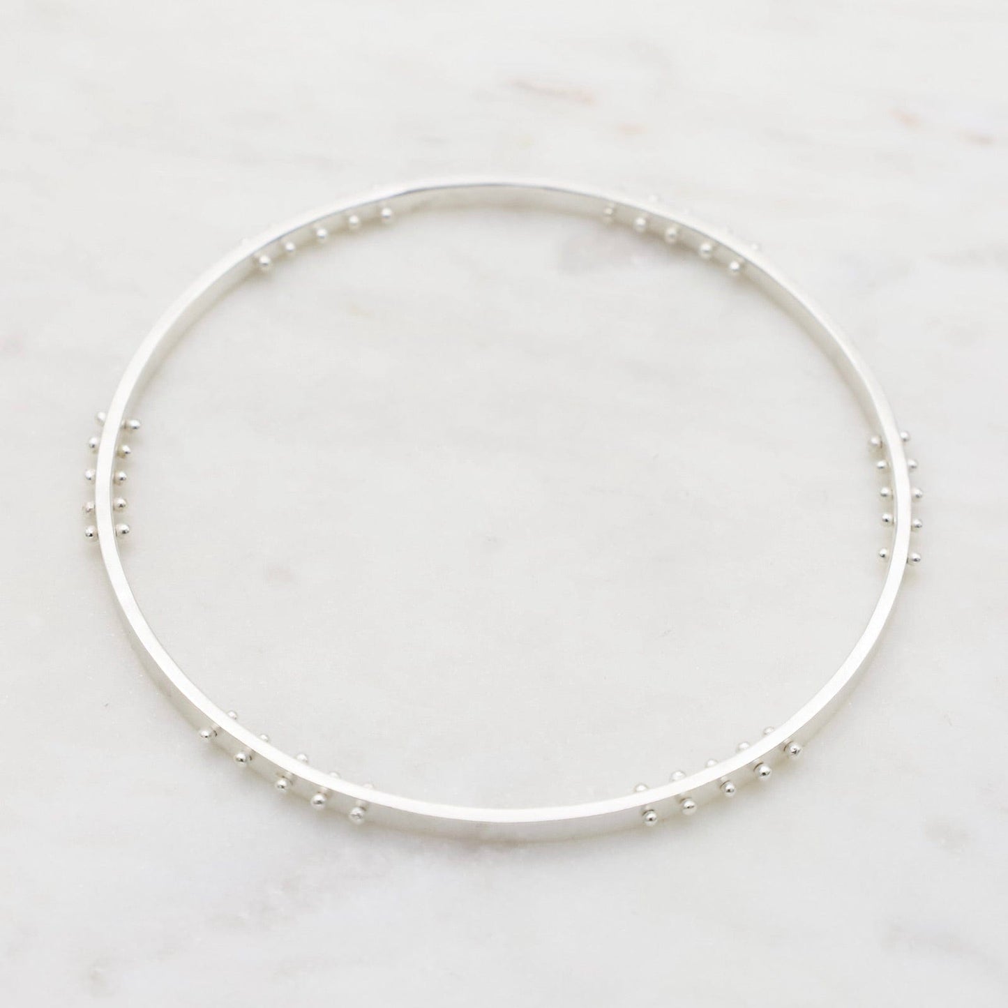 Load image into Gallery viewer, BRC Five Kinetic Dot Bangle in Polished Silver
