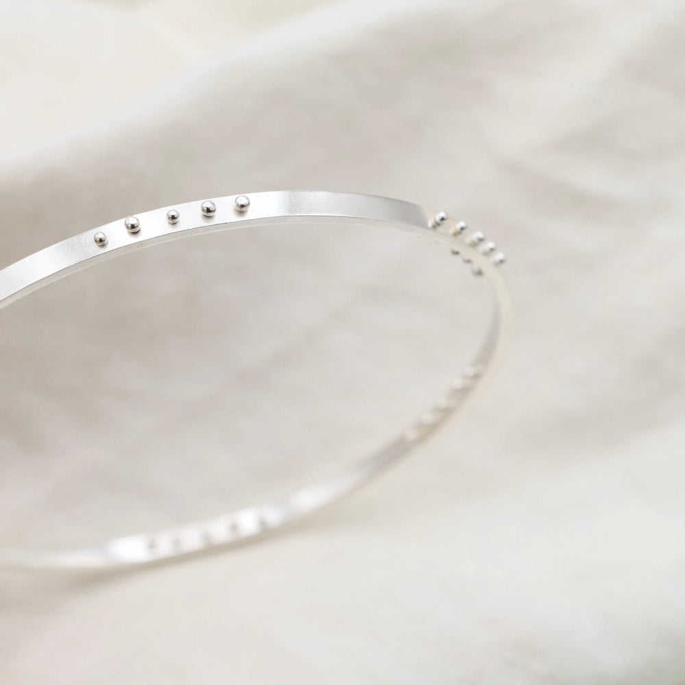 
                  
                    BRC Five Kinetic Dot Bangle in Polished Silver
                  
                