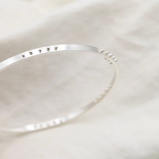 Load image into Gallery viewer, BRC Five Kinetic Dot Bangle in Polished Silver
