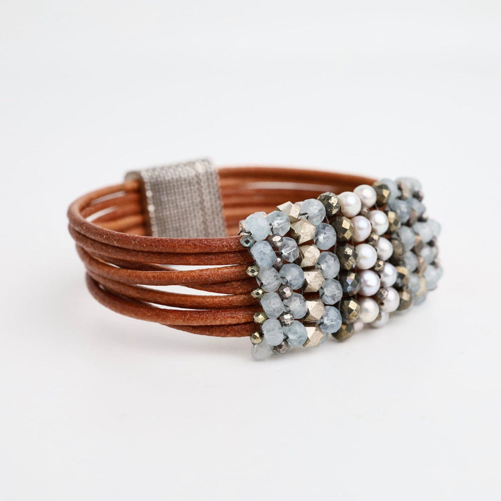 
                  
                    BRC-JM Hand Stitched Aquamarine, Grey Pearls, Pyrite, & Silver on Natural Leather Bracelet
                  
                