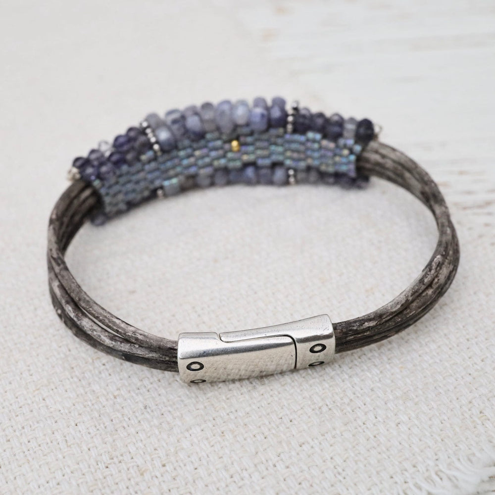 
                  
                    BRC-JM Hand Stitched Banded Iolite with Silver Trim on Mu
                  
                