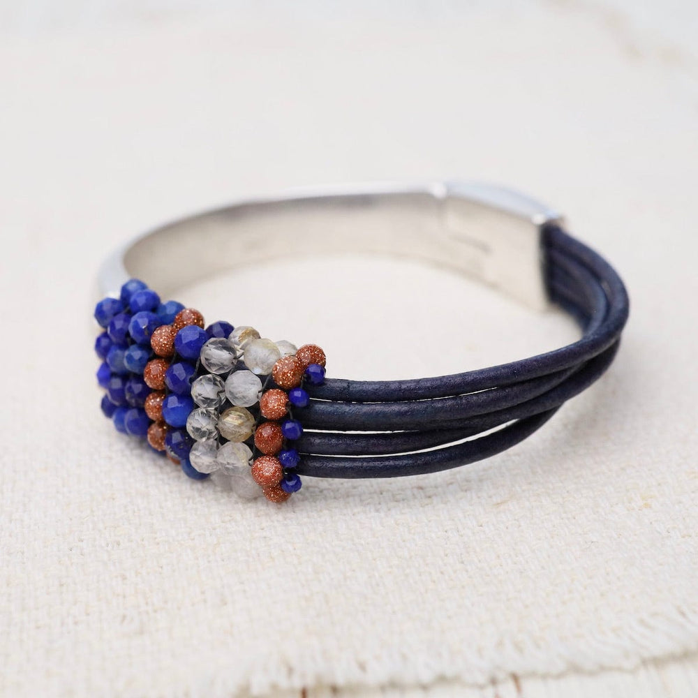 
                      
                        BRC-JM Hand Stitched Lapis, Rutilated Quartz, & Goldstone Leather Bracelet
                      
                    