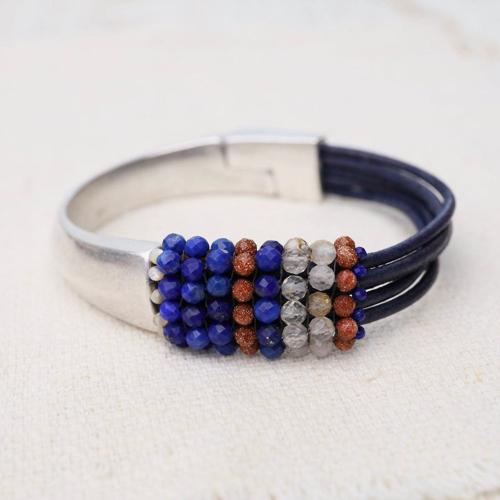 
                      
                        BRC-JM Hand Stitched Lapis, Rutilated Quartz, & Goldstone Leather Bracelet
                      
                    