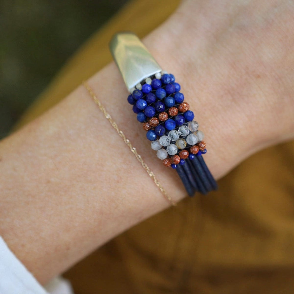 
                      
                        BRC-JM Hand Stitched Lapis, Rutilated Quartz, & Goldstone Leather Bracelet
                      
                    