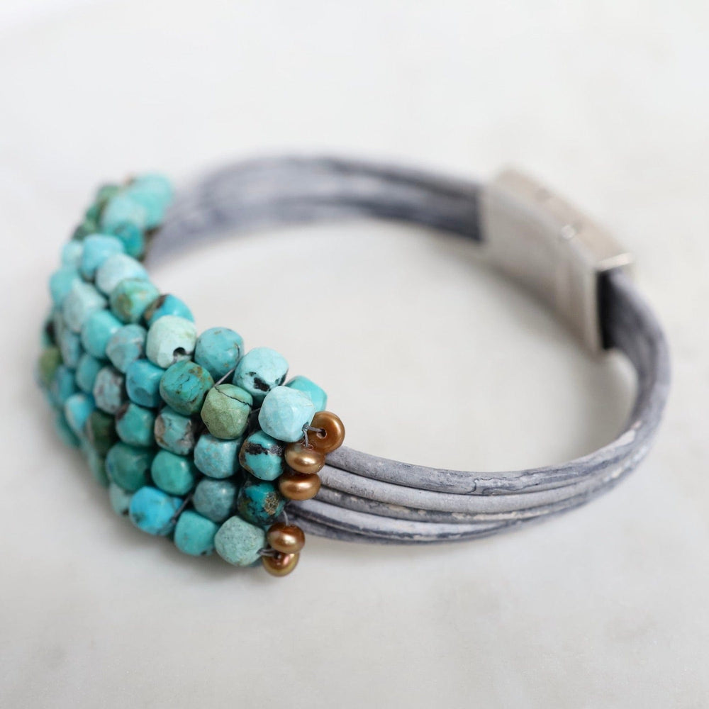 
                  
                    BRC-JM Hand Stitched Large Turquoise Cubes with Copper Pearl Trim on Multi Driftwood Leather Bracelet
                  
                