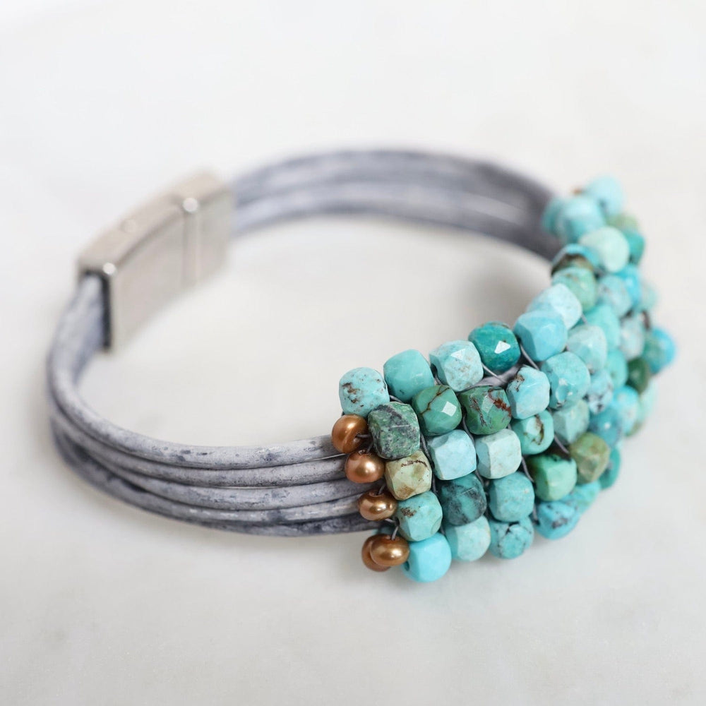 
                  
                    BRC-JM Hand Stitched Large Turquoise Cubes with Copper Pearl Trim on Multi Driftwood Leather Bracelet
                  
                