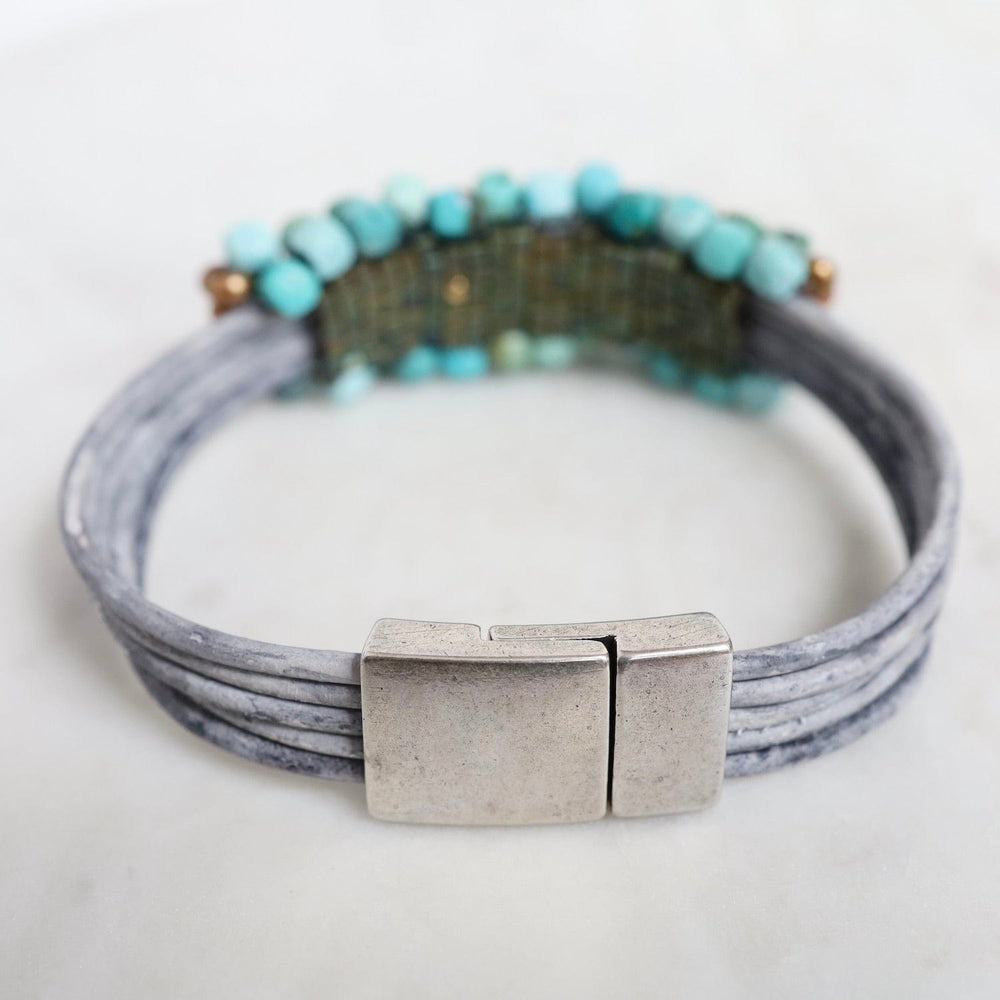 
                  
                    BRC-JM Hand Stitched Large Turquoise Cubes with Copper Pearl Trim on Multi Driftwood Leather Bracelet
                  
                