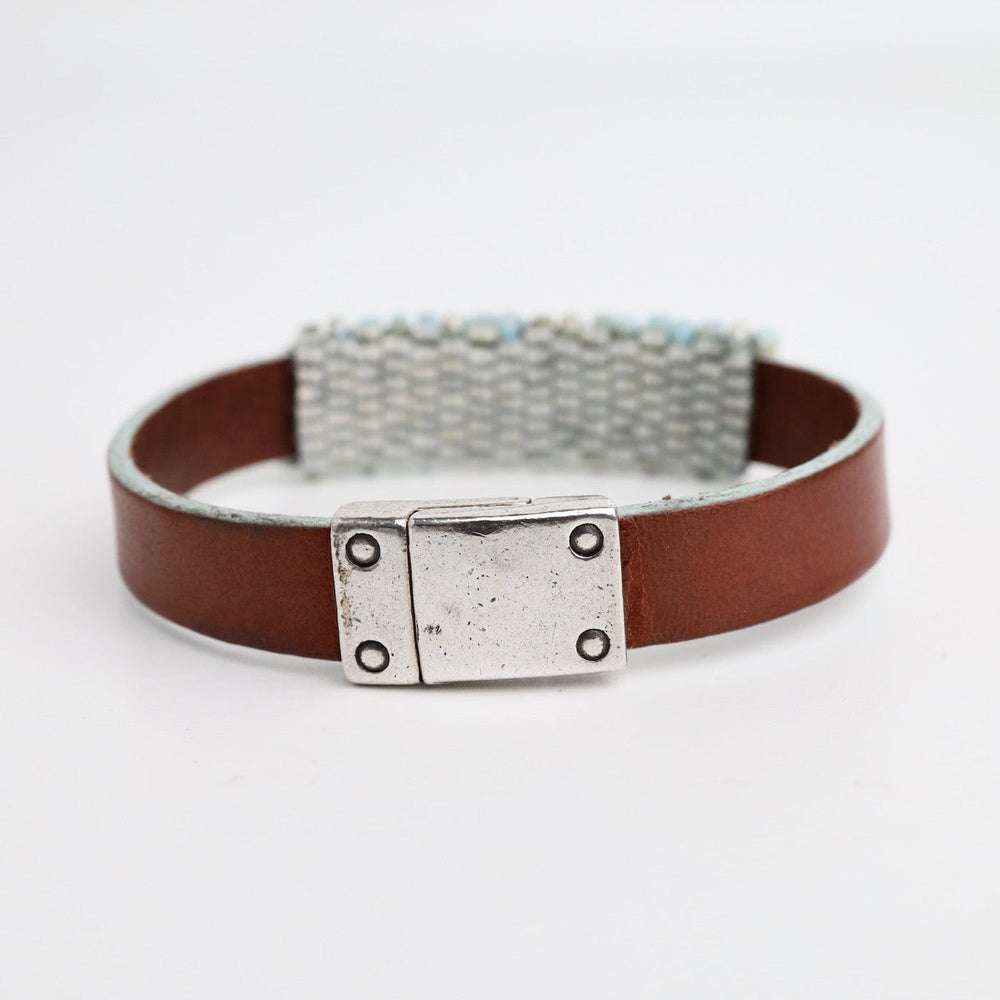 
                  
                    BRC-JM Hand Stitched Light Turquoise Cube Crystals on Leather Bracelet
                  
                