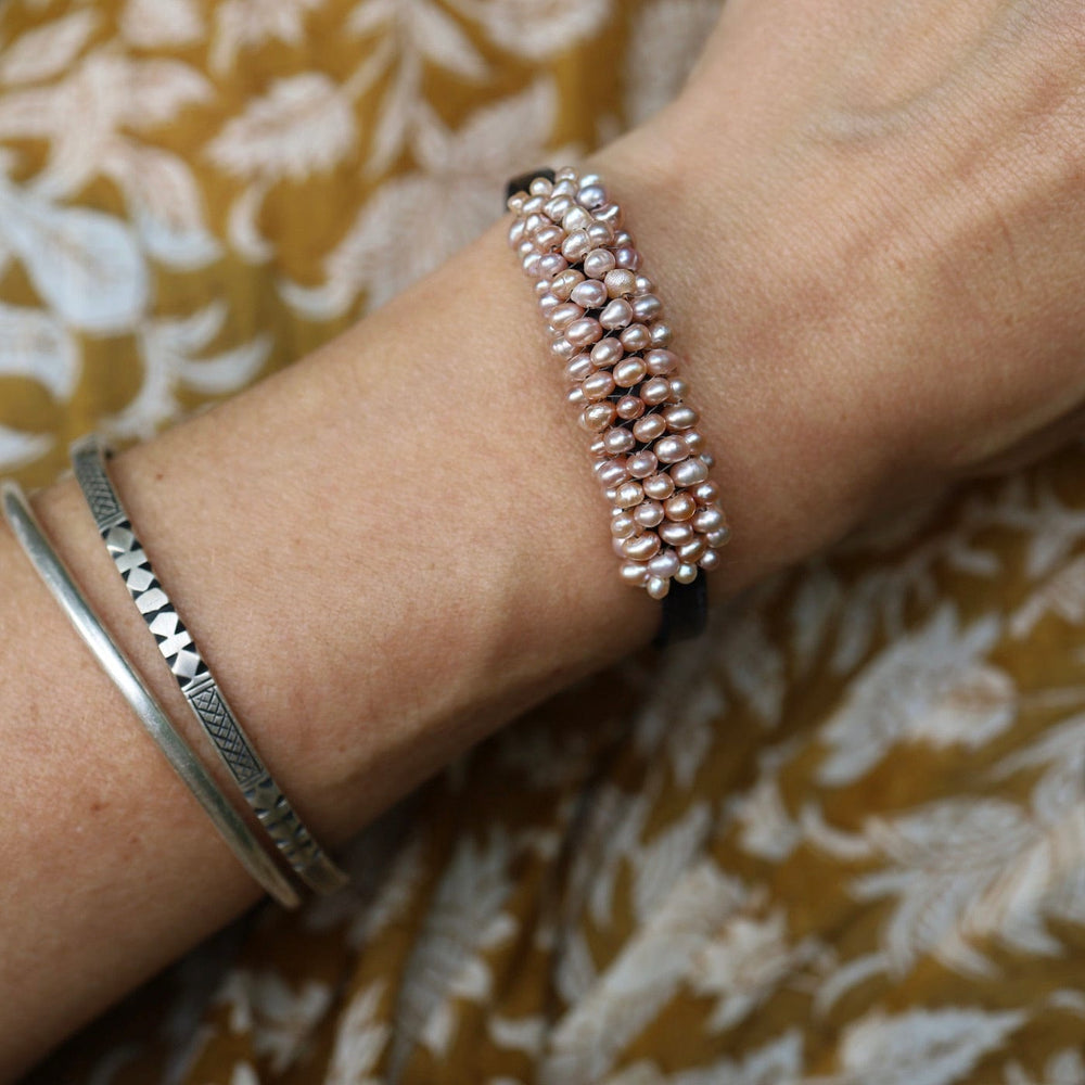 
                  
                    BRC-JM Hand Stitched Pink Pearls on 5mm Vintage Black Leather Bracelet
                  
                