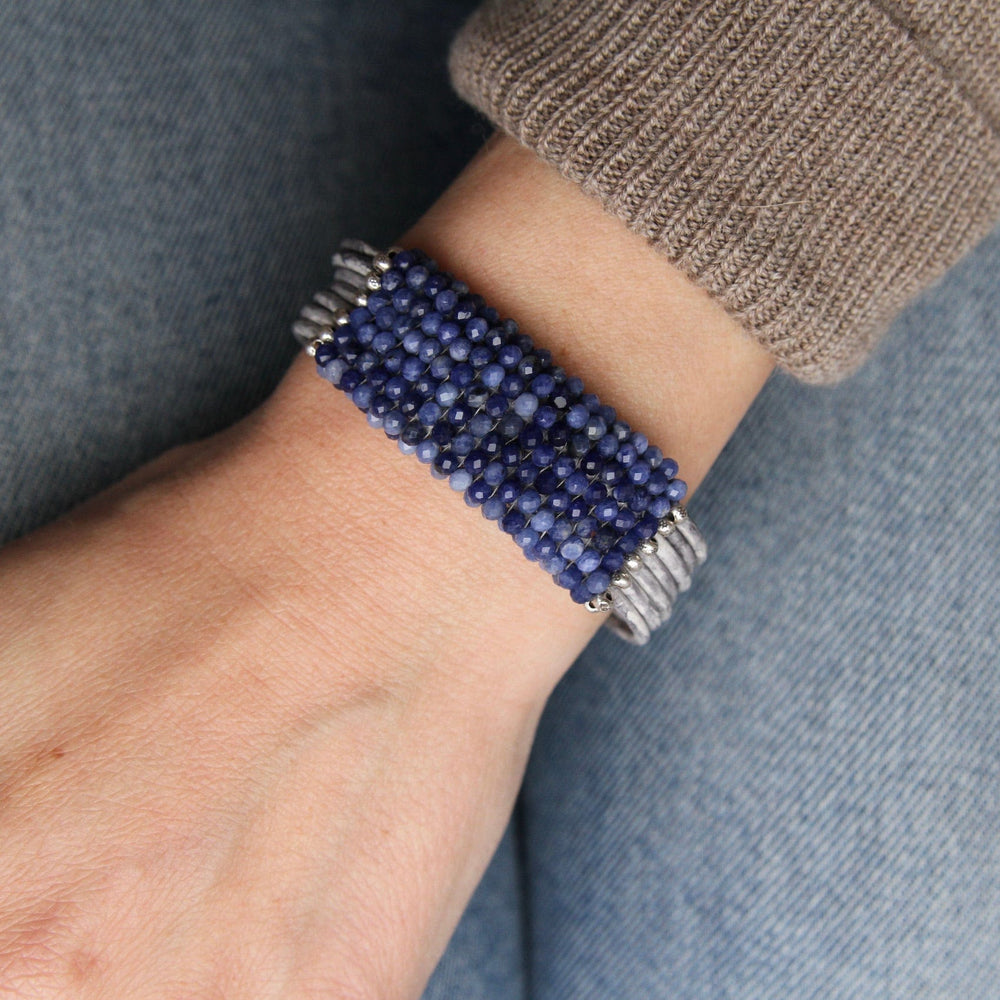 
                  
                    BRC-JM Hand Stitched Shaded Sodalite with Hill Tribe Stamped Fine Silver Bead Trim Bracelet
                  
                