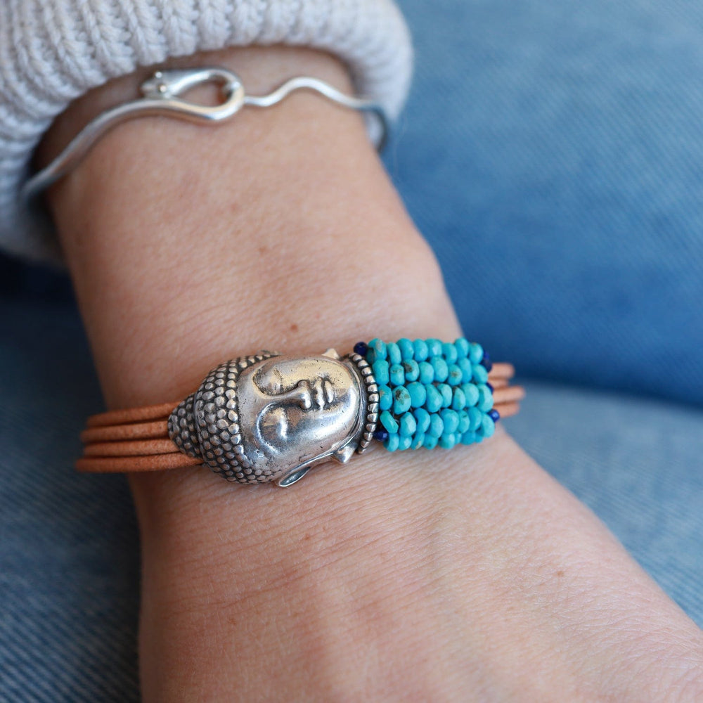 
                  
                    BRC-JM Hand Stitched Sleeping Beauty Turquoise with Lapis Trim & Buddha Clasp Bracelet
                  
                