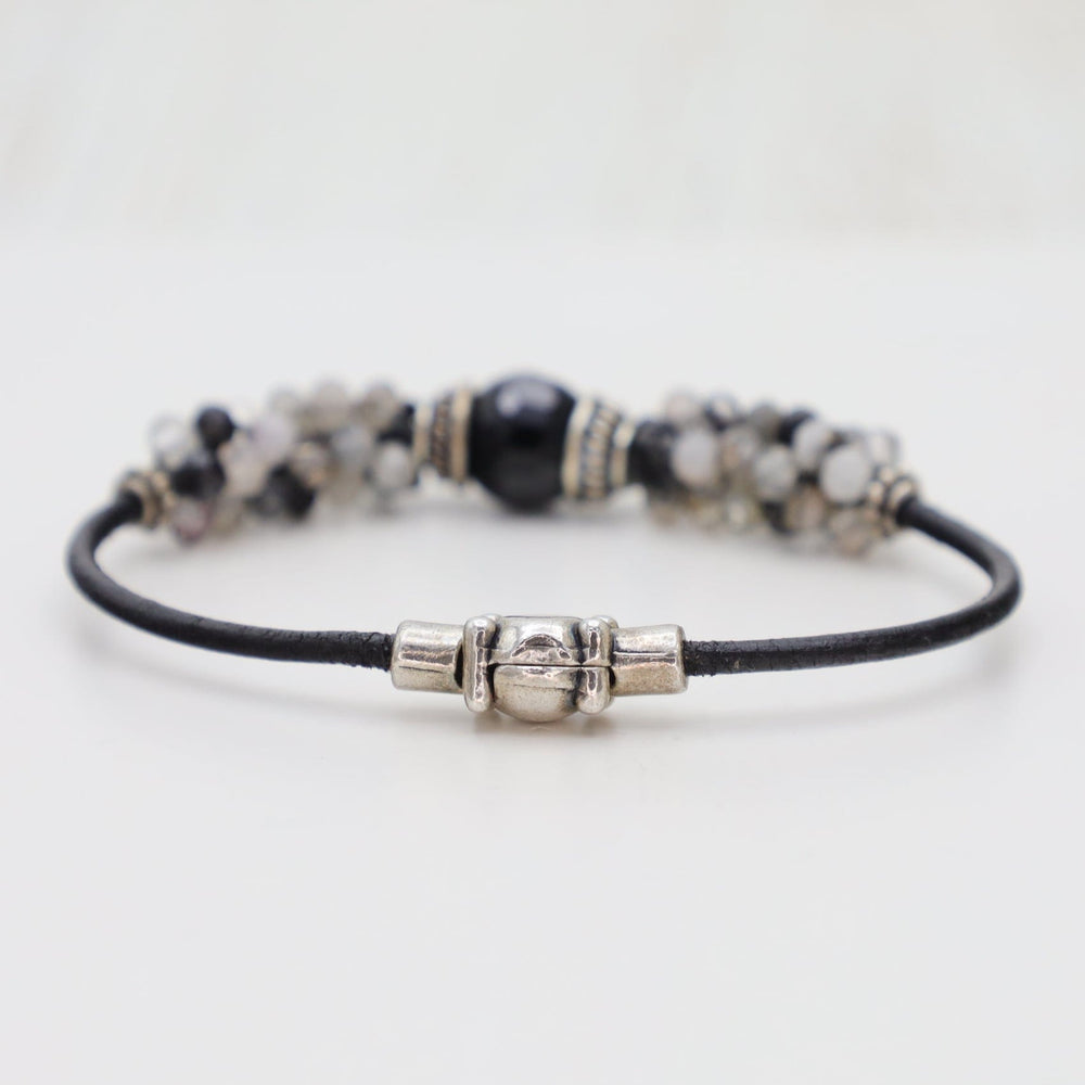 
                  
                    BRC-JM Hand Stitched Tourmalated Quartz & Large Black Onyx Bracelet
                  
                