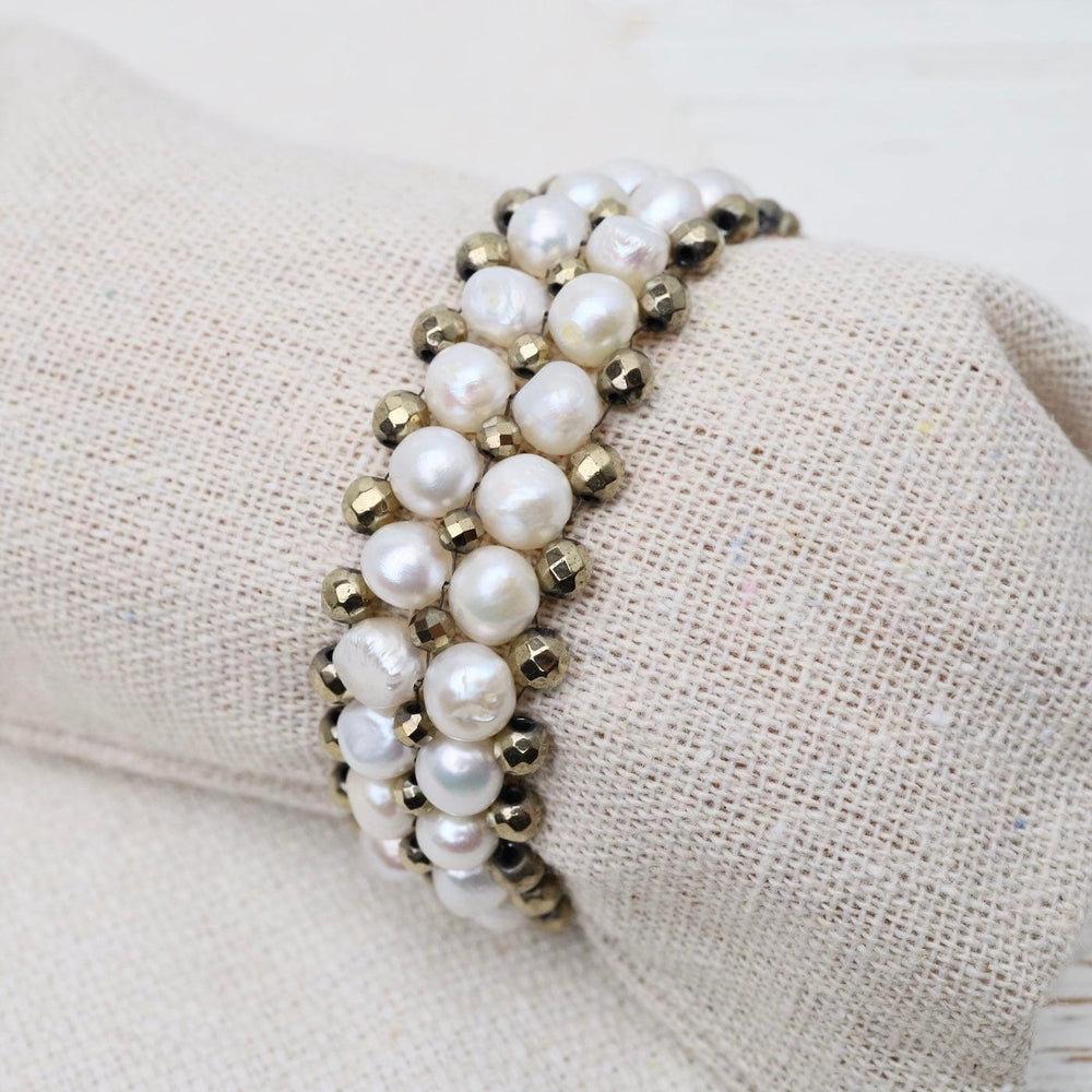 
                  
                    BRC-JM Hand Woven Soft Bracelet of White Pearls & Pyrite
                  
                