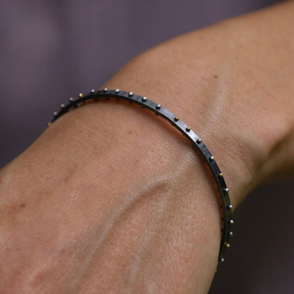 
                  
                    BRC Orbit Bangle - Oxidized Silver with Mix Metal Dots
                  
                