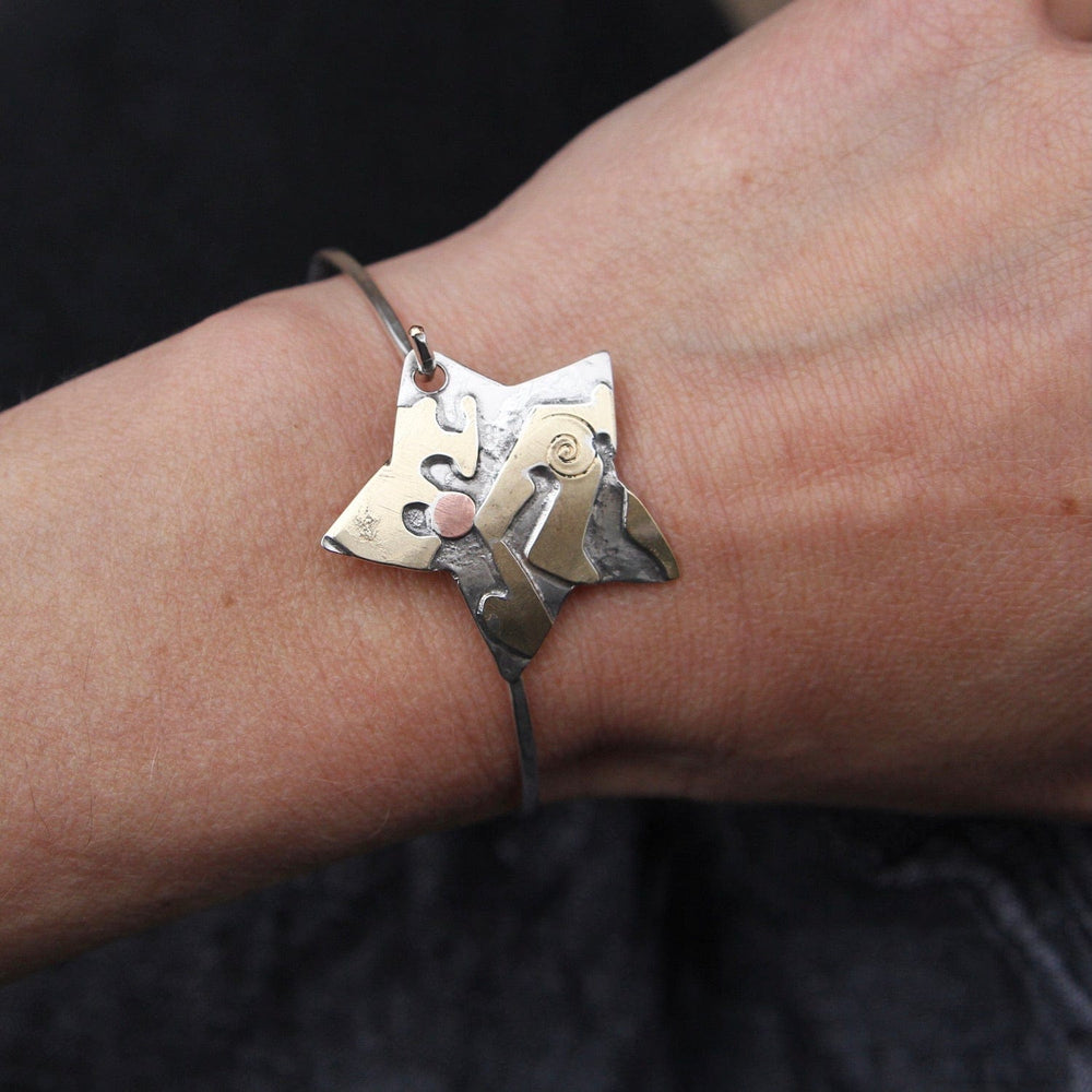 
                  
                    BRC Silver Star with Abstract Brass Cutouts Latching Bracelet
                  
                