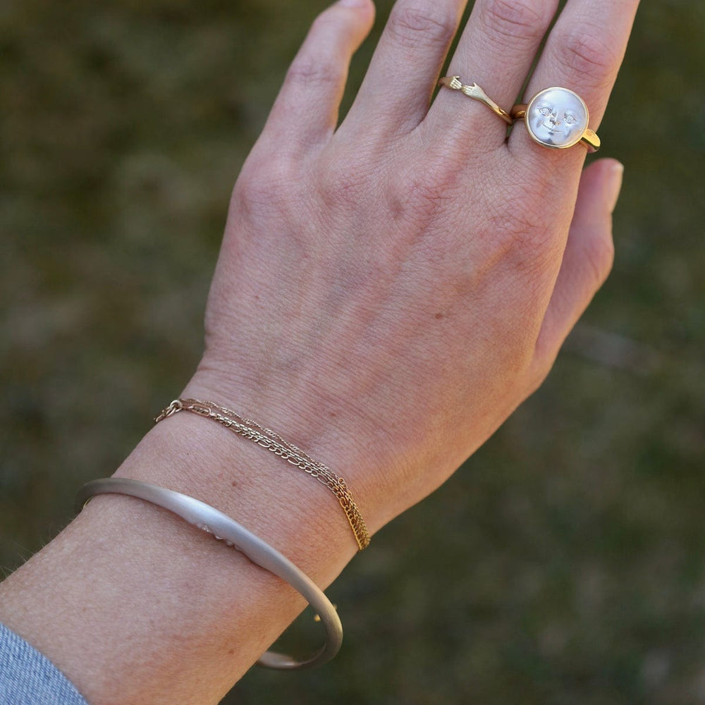 
                      
                        BRC Sterling Silver Crescent Moonface Bangle
                      
                    