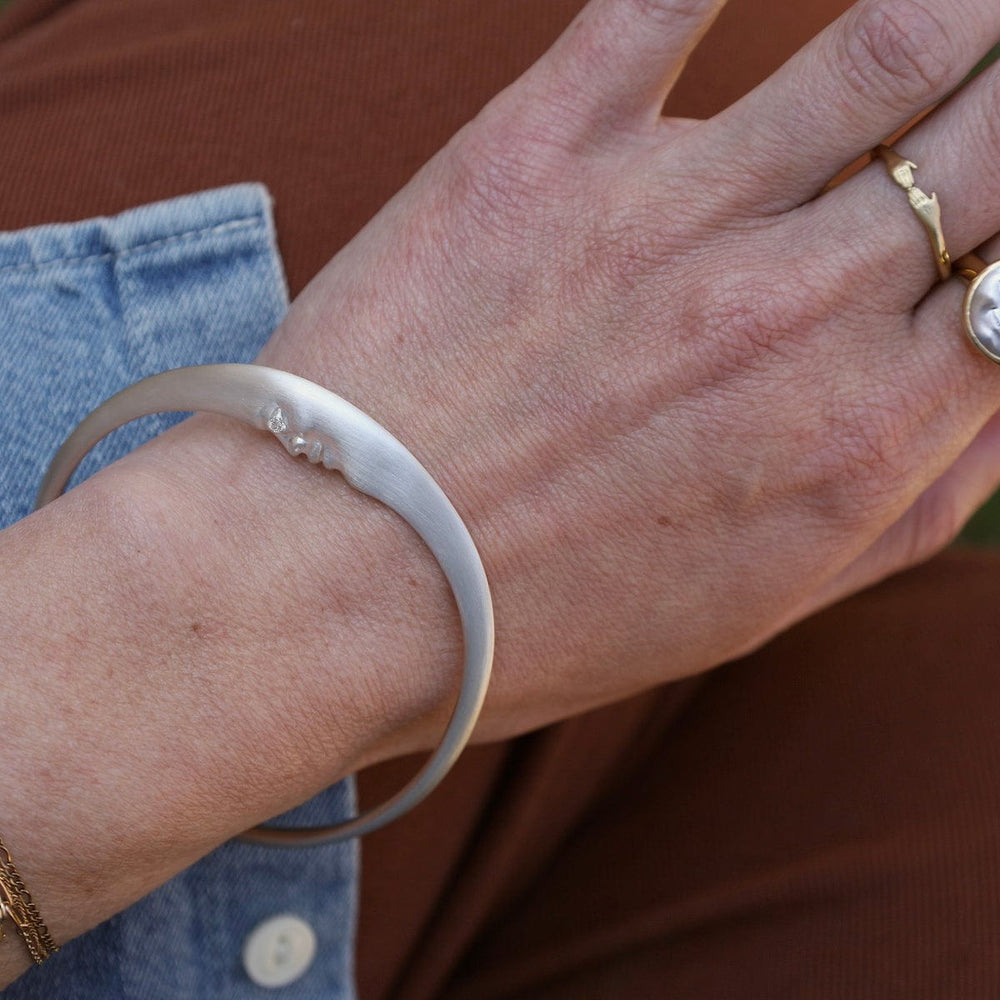 
                      
                        BRC Sterling Silver Crescent Moonface Bangle
                      
                    