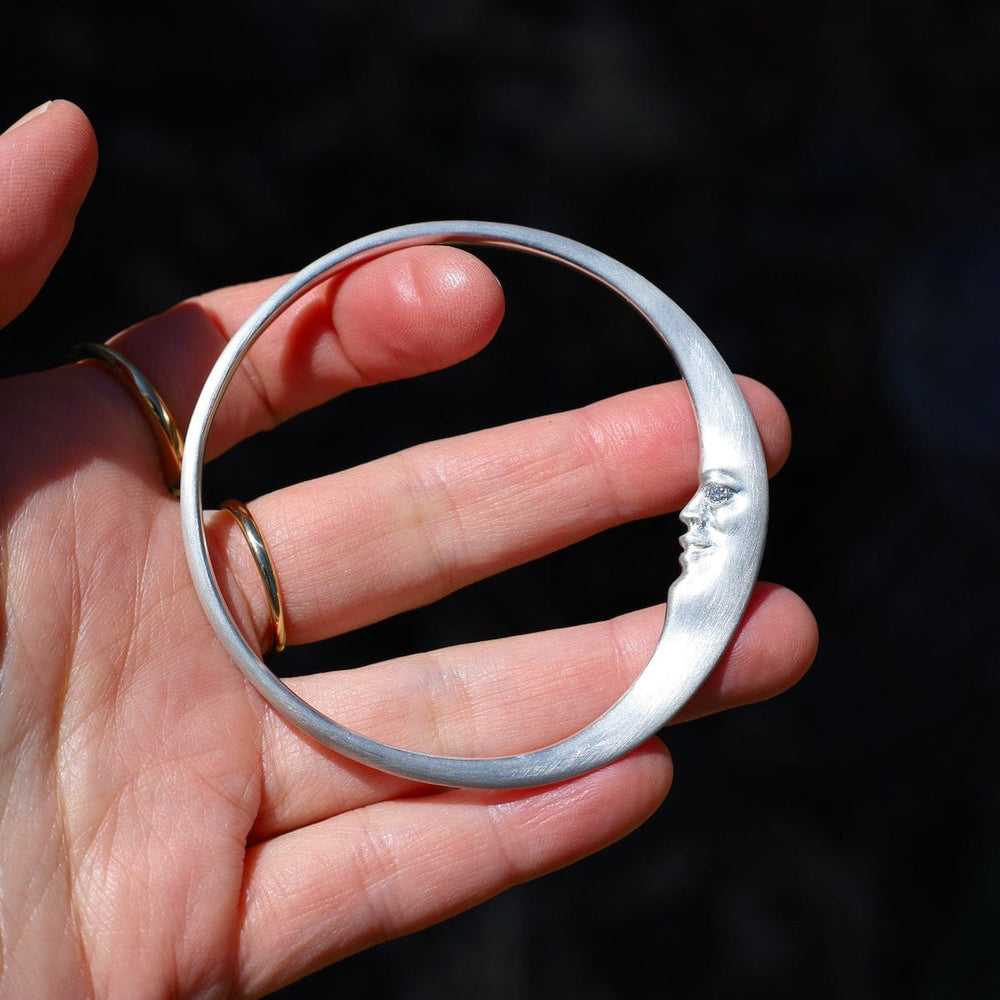 
                      
                        BRC Sterling Silver Crescent Moonface Bangle
                      
                    