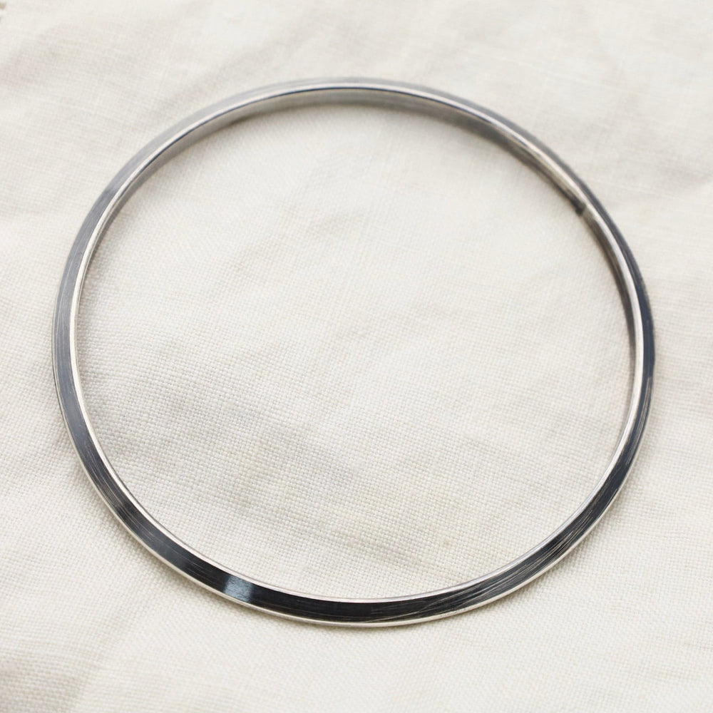 
                  
                    BRC Thin Triangle Bangle in Oxidized Silver
                  
                