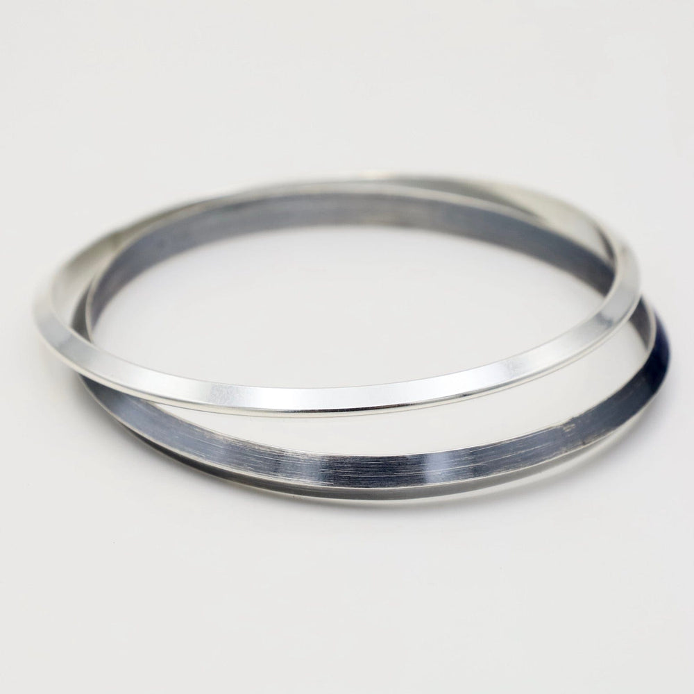 
                  
                    BRC Thin Triangle Bangle in Polished Silver
                  
                