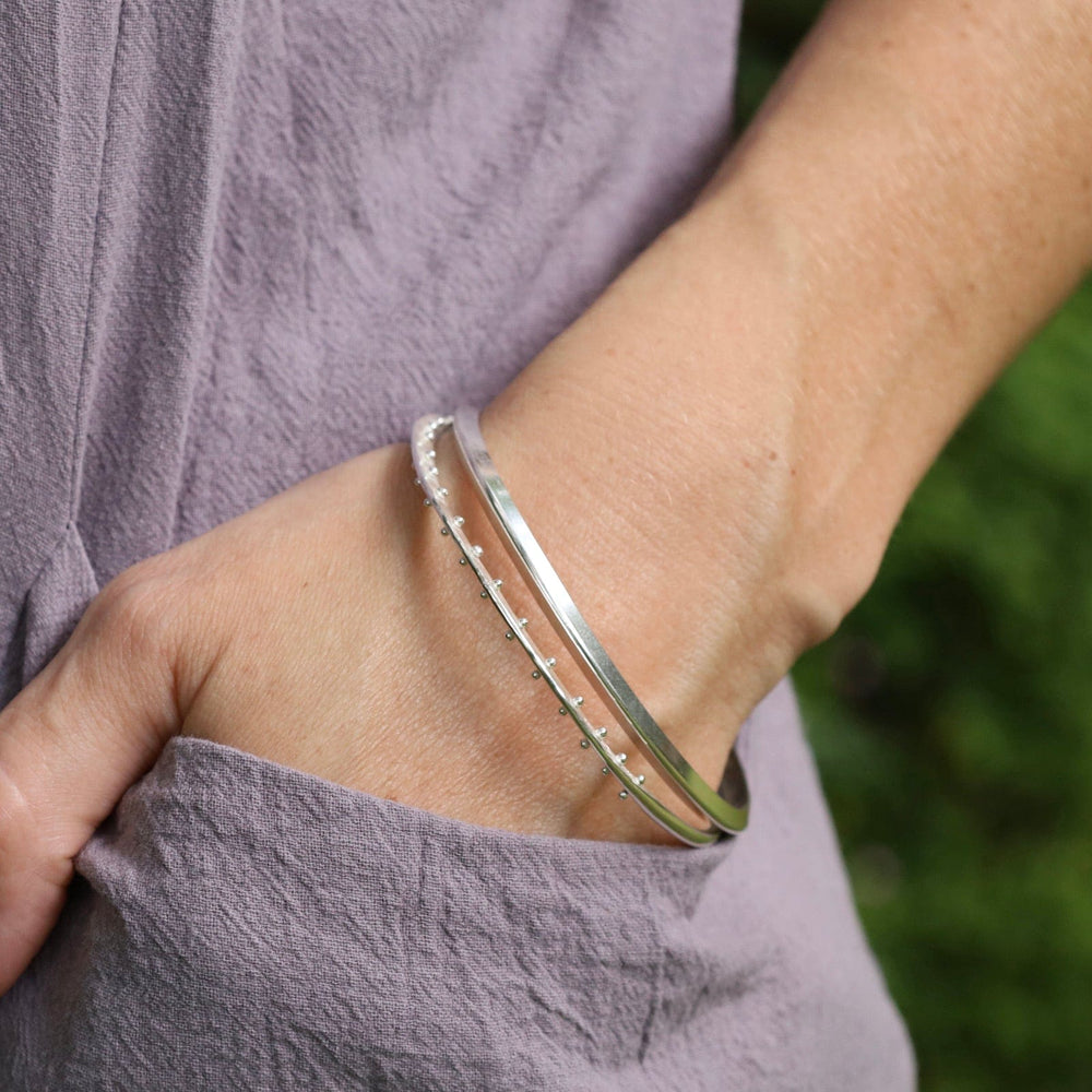 
                  
                    BRC Thin Triangle Bangle in Polished Silver
                  
                