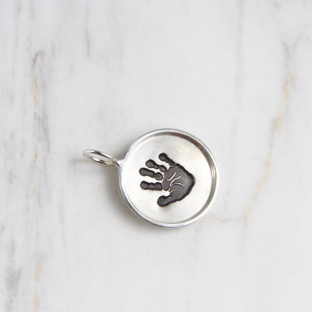 
                  
                    CHM Handprint Small Silver Round Disc with Silver Frame Charm
                  
                