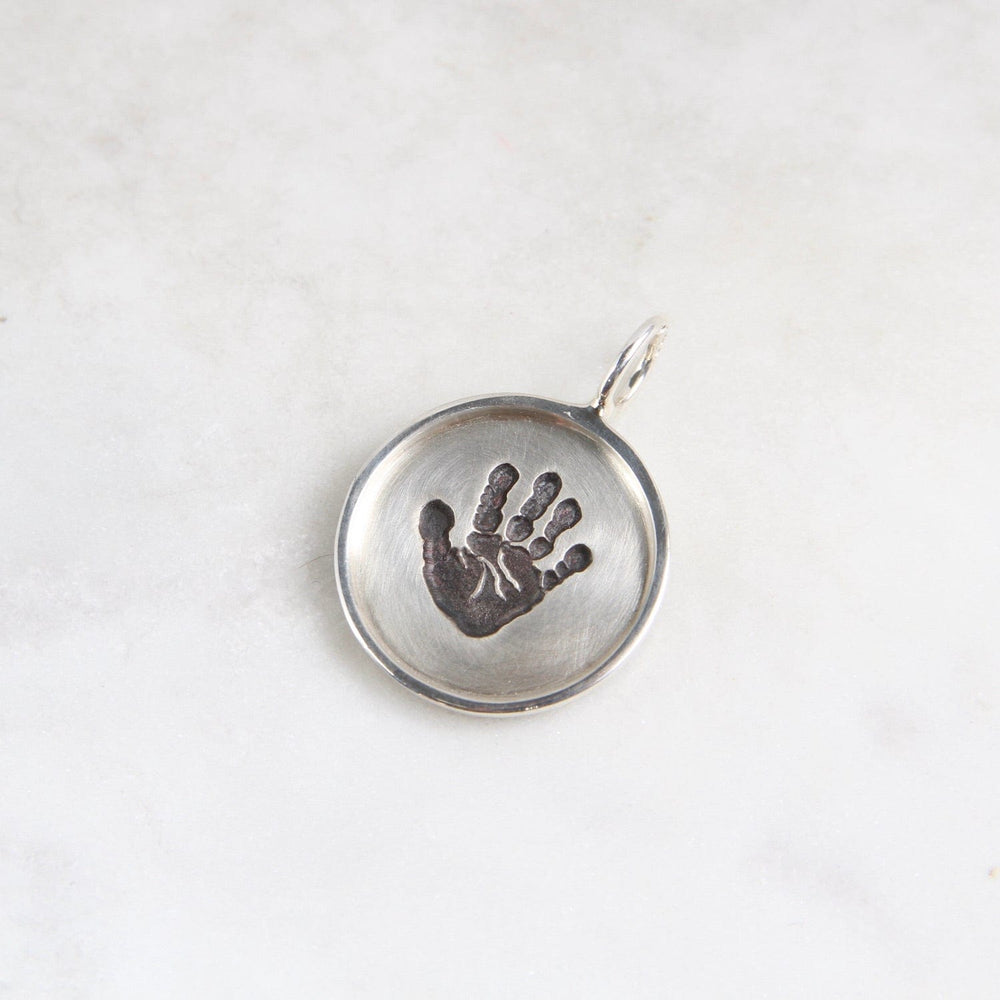 
                  
                    CHM Handprint Small Silver Round Disc with Silver Frame Charm
                  
                