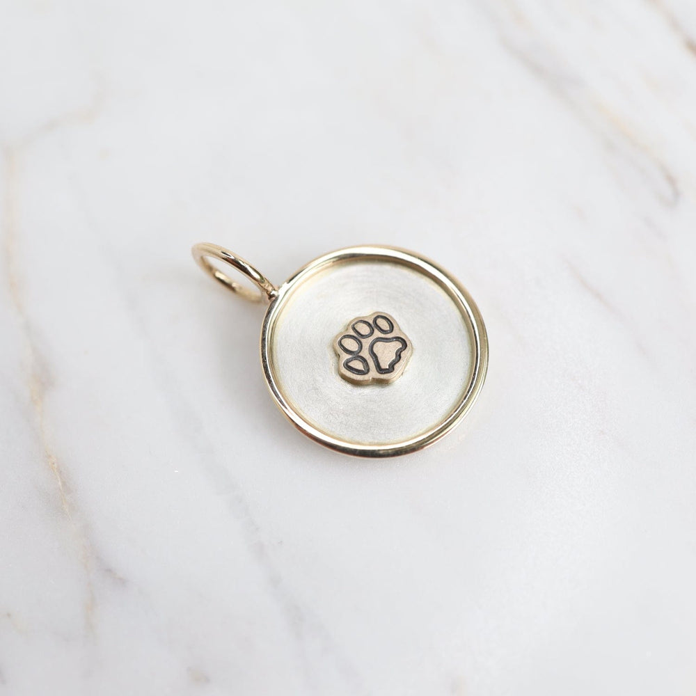 
                  
                    CHM Stamped Raised Paw Print Charm with 14k Gold Frame
                  
                