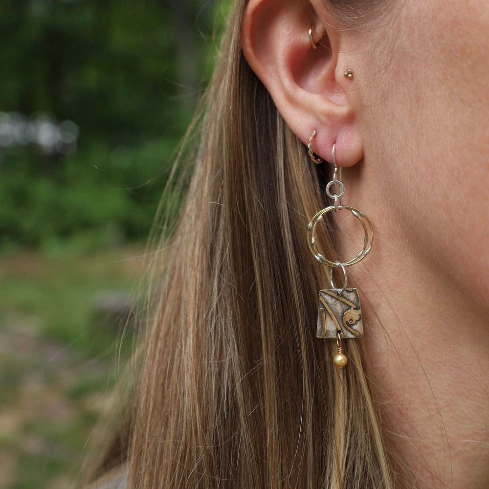 
                      
                        EAR Dancing Particles Earrings
                      
                    