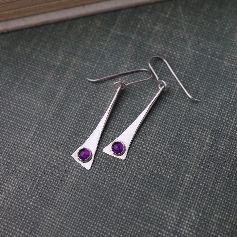 
                      
                        EAR ELONGATED TRIANGLE EARRING W/ AMETHYST CAB
                      
                    