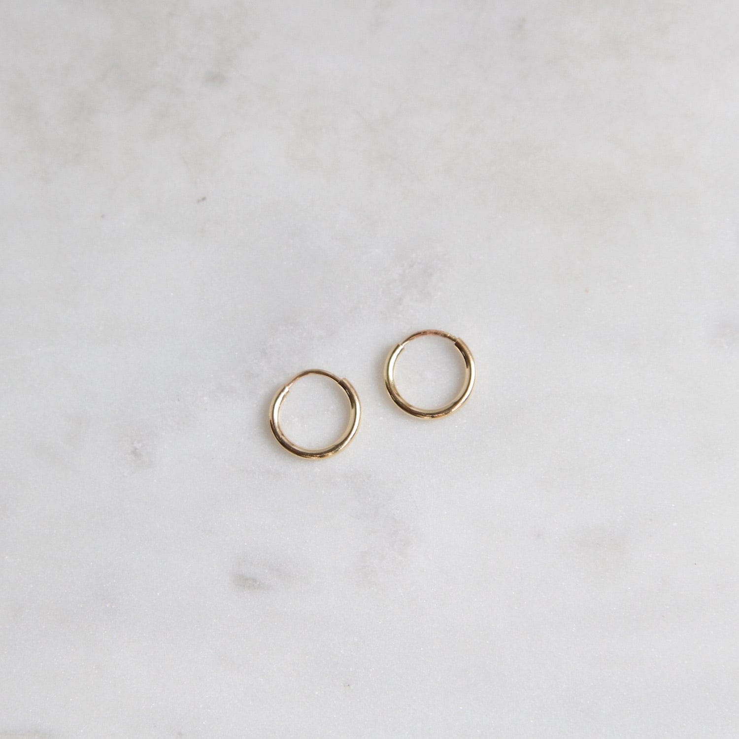 infinity hoop earrings { gold + silver }