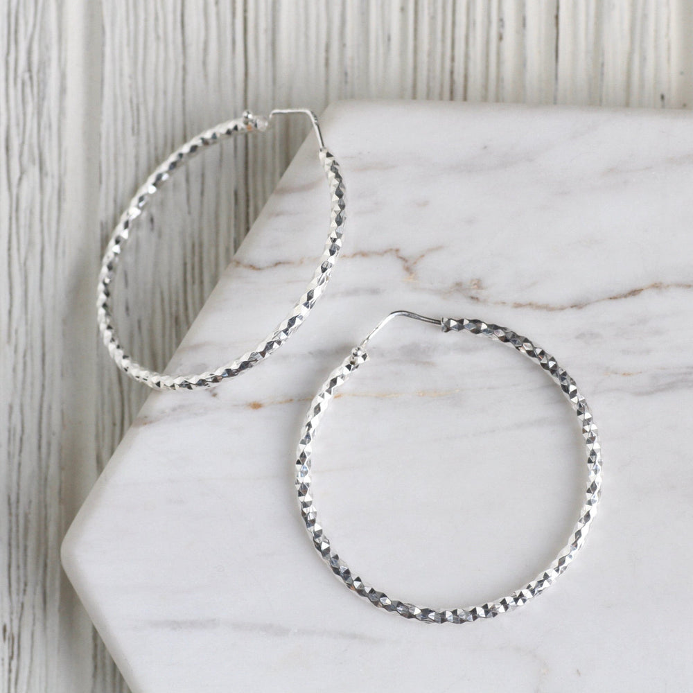 
                  
                    EAR Large Sterling Silver Faceted Hoops
                  
                