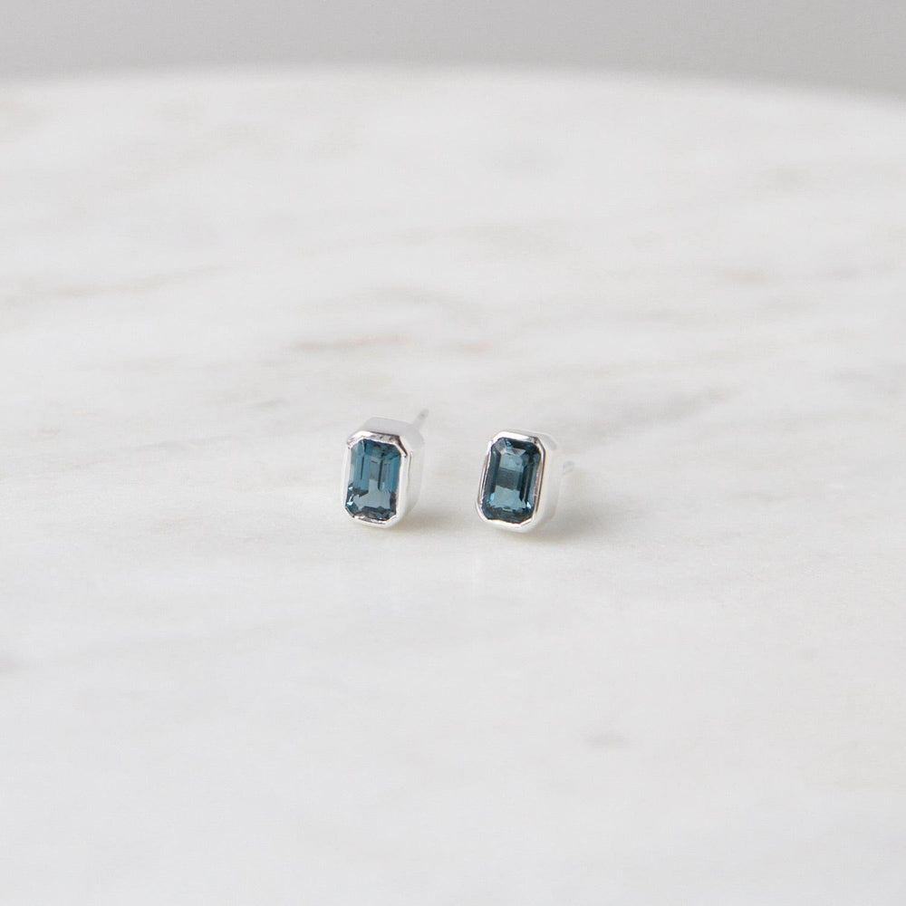 
                      
                        EAR Sterling Silver Bezel Set Emerald Cut London Blue Topaz
                      
                    