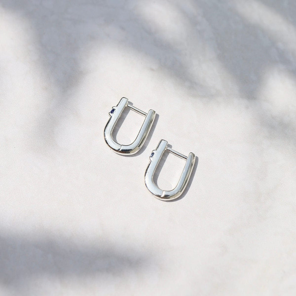 
                      
                        EAR U Shaped Huggie Hoops with Blue Sapphire in Sterling Silver
                      
                    