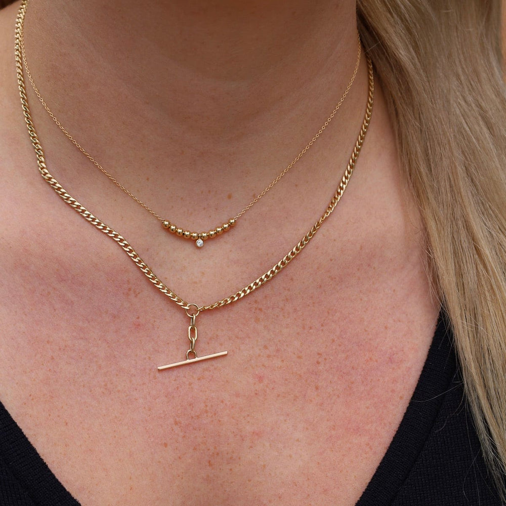 
                  
                    NKL-14K 14k Gold Mixed Small Curb Chain Faux Toggle Lariat
                  
                