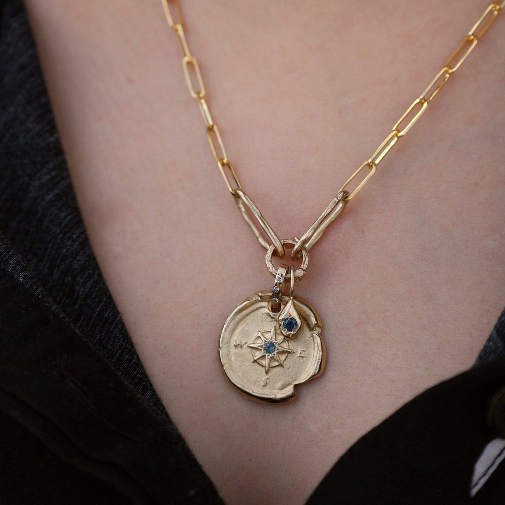 
                      
                        NKL-14K 14k Yellow Gold Compass & Paperclip Necklace with Montana Sapphire
                      
                    