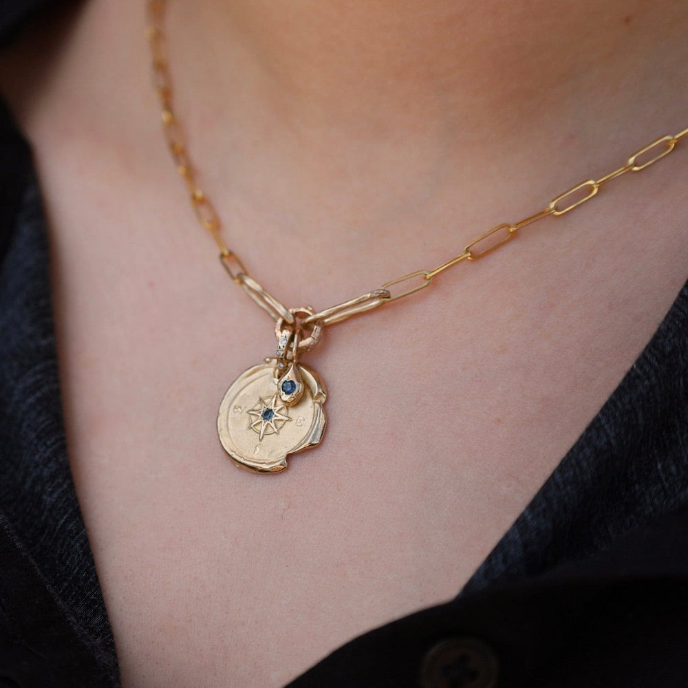 
                      
                        NKL-14K 14k Yellow Gold Compass & Paperclip Necklace with Montana Sapphire
                      
                    