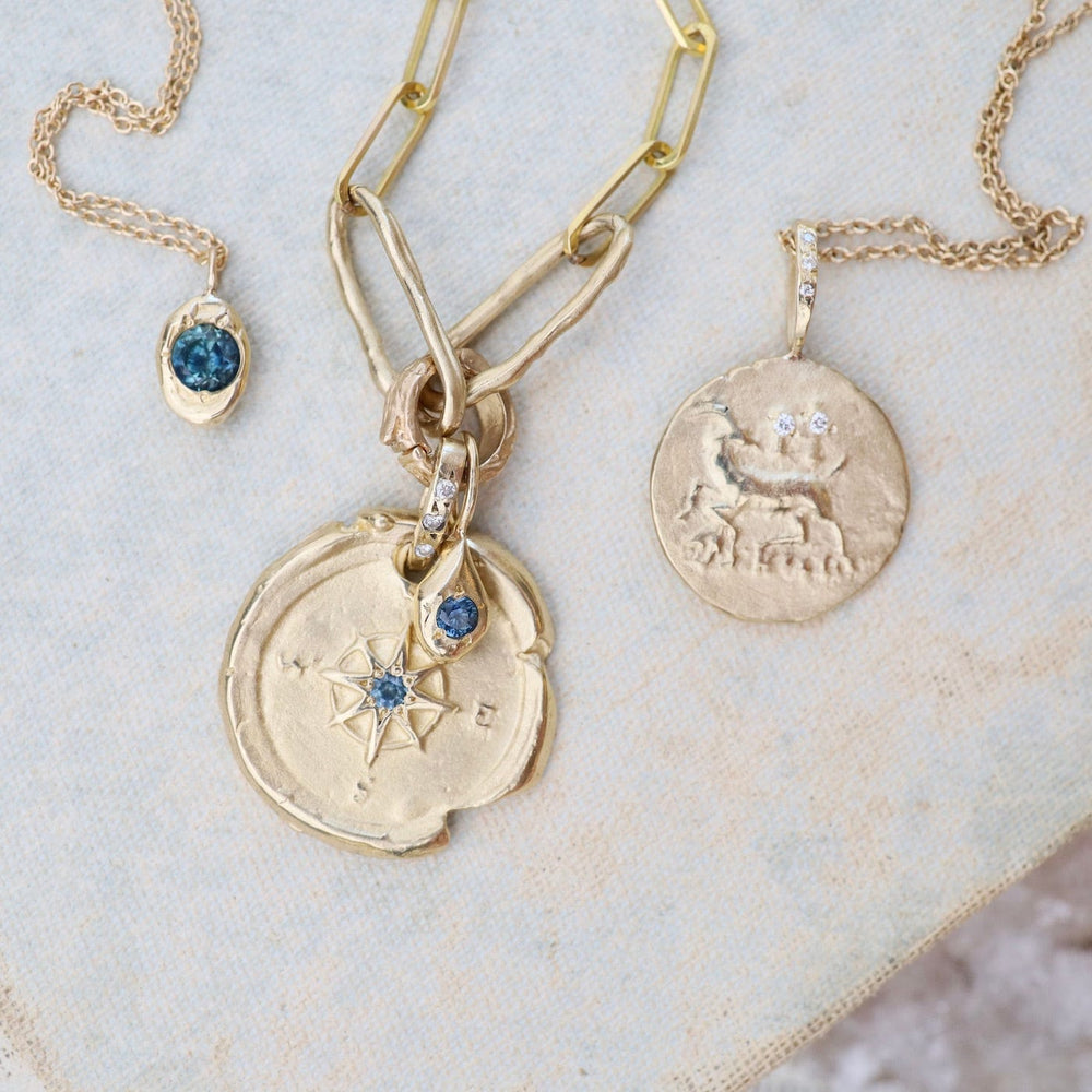 
                      
                        NKL-14K 14k Yellow Gold Compass & Paperclip Necklace with Montana Sapphire
                      
                    