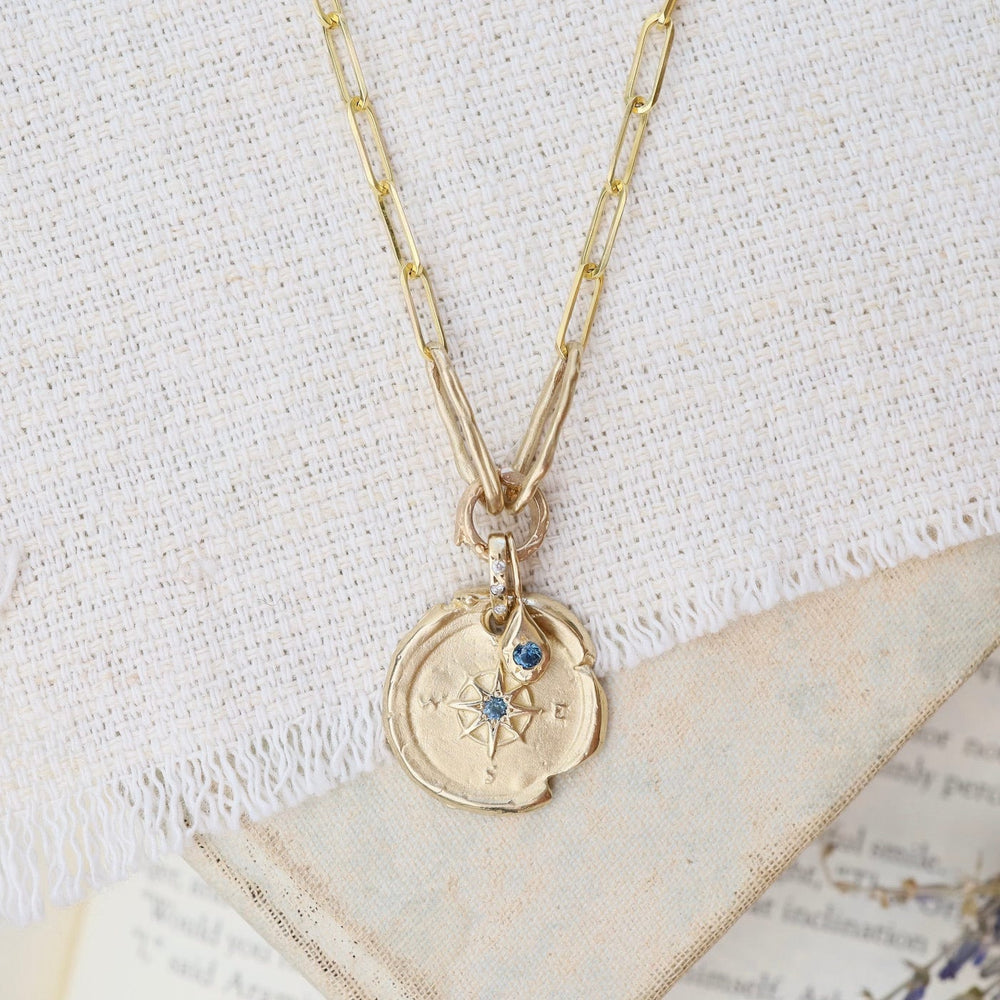 
                      
                        NKL-14K 14k Yellow Gold Compass & Paperclip Necklace with Montana Sapphire
                      
                    