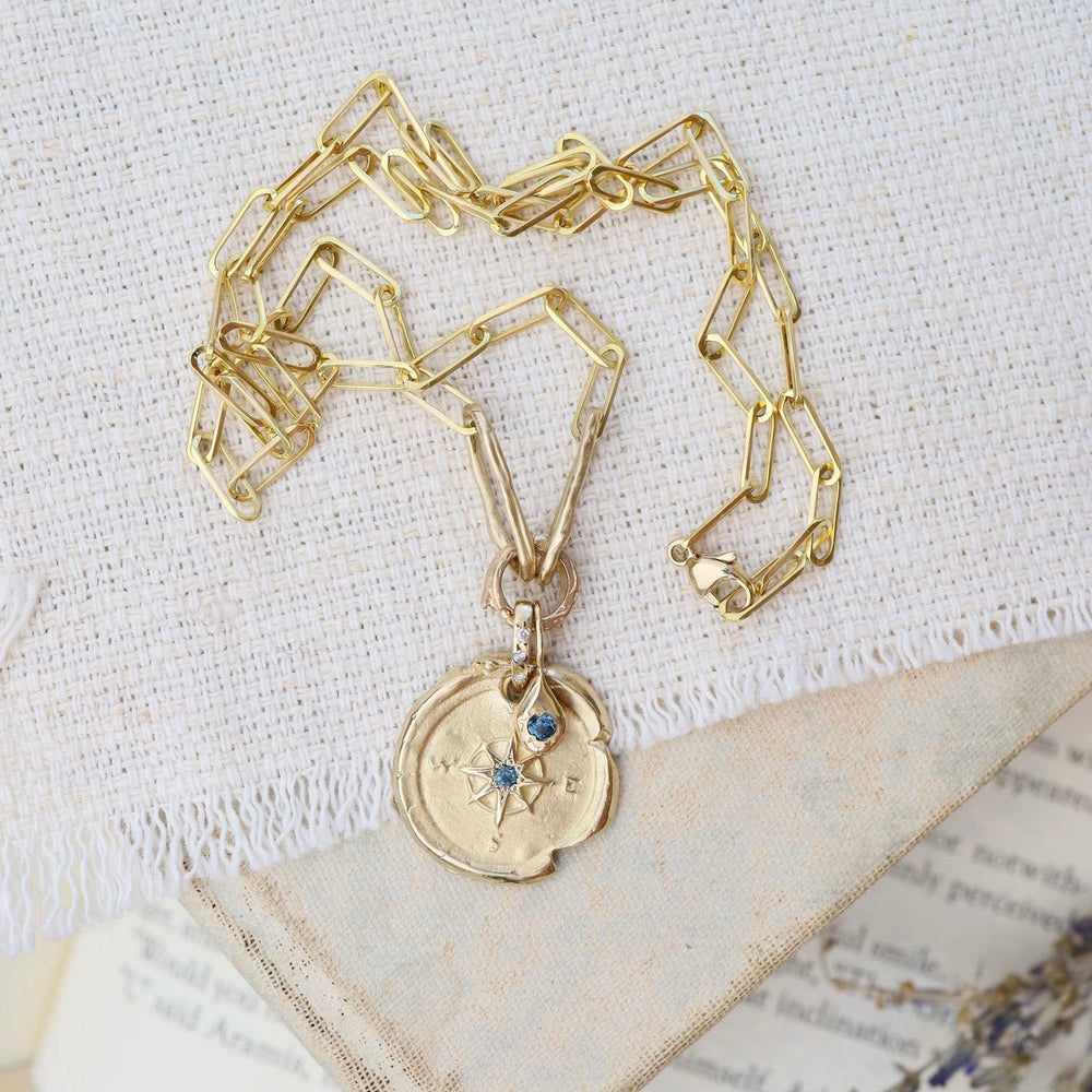 
                      
                        NKL-14K 14k Yellow Gold Compass & Paperclip Necklace with Montana Sapphire
                      
                    