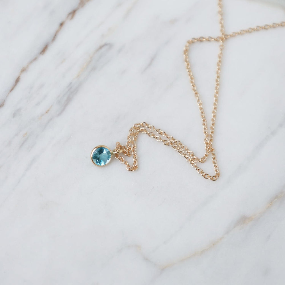 
                  
                    NKL-14K Yellow Gold & Dark Blue Topaz Solitaire Necklace
                  
                