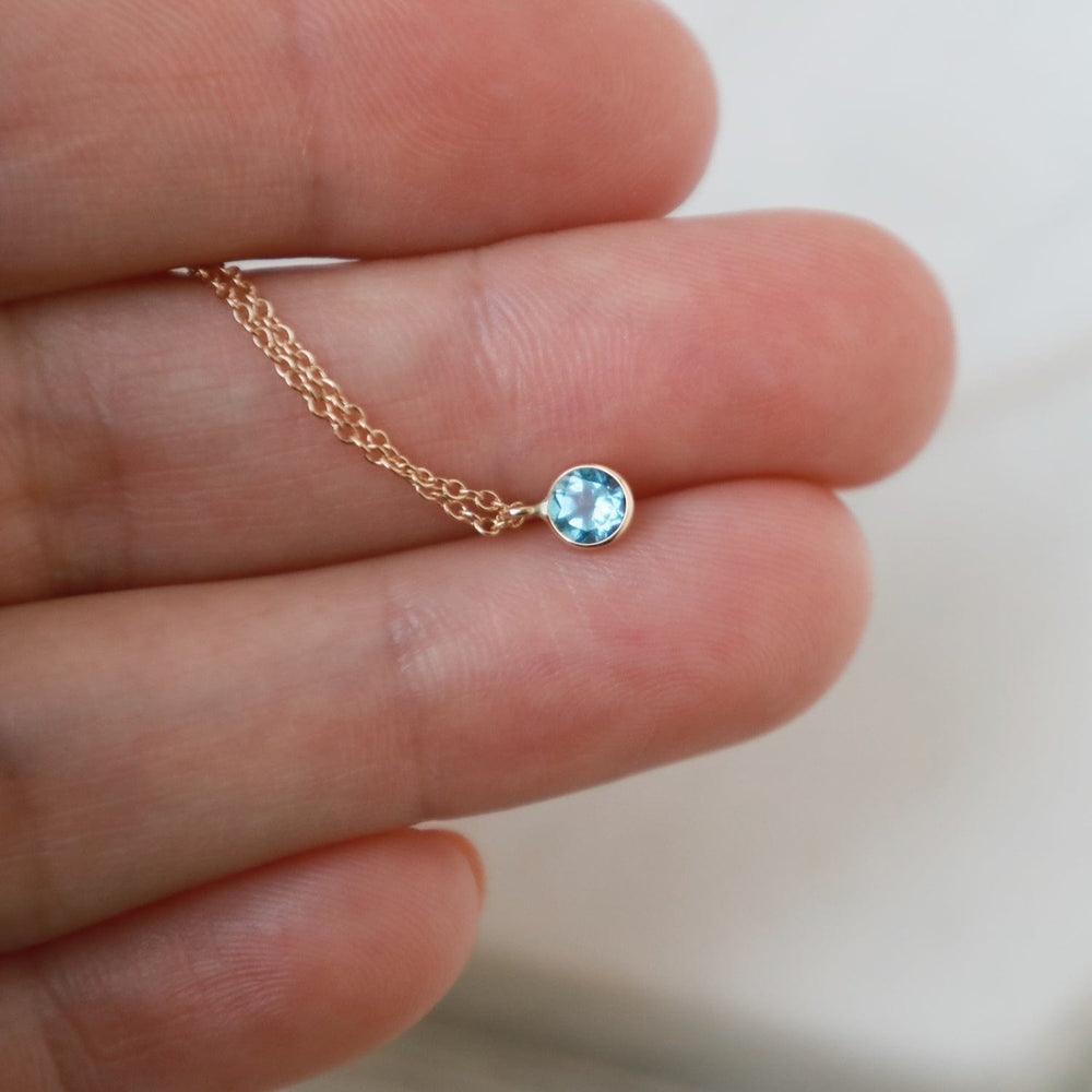 
                  
                    NKL-14K Yellow Gold & Dark Blue Topaz Solitaire Necklace
                  
                