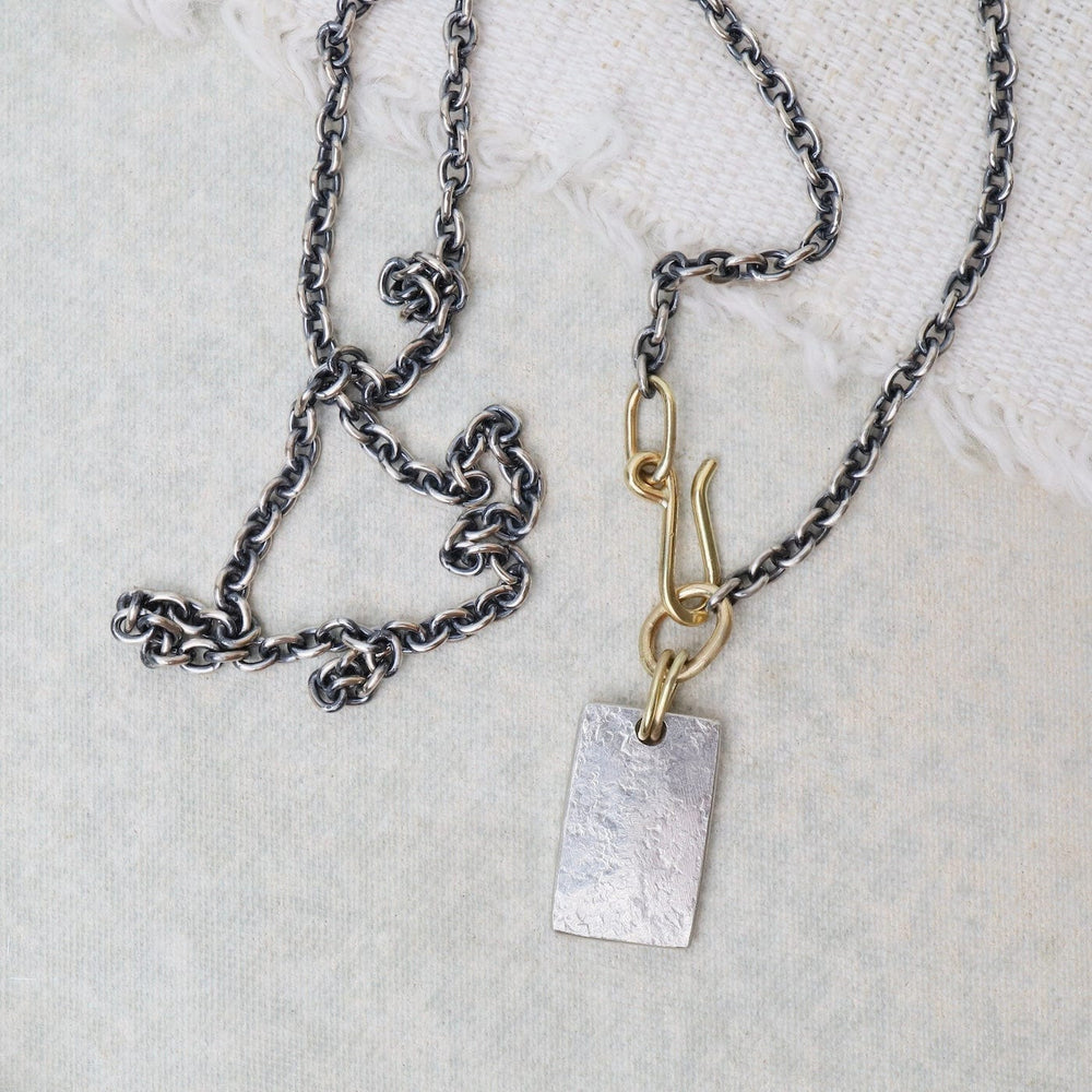 
                      
                        NKL-18K Silver Tablet Necklace with 18K Details
                      
                    