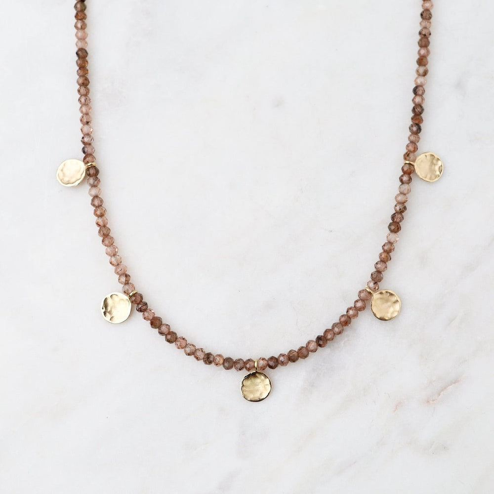 
                      
                        NKL-18K 'Wrap' Champagne Garnet Mini Hammered Disc Necklace
                      
                    