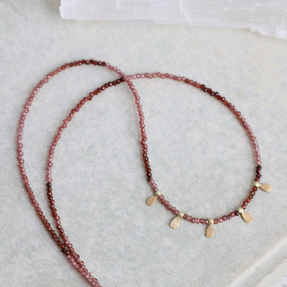 
                      
                        NKL-22K Beaded Ombre Rhonolite Garnet Necklace with 5 22k
                      
                    